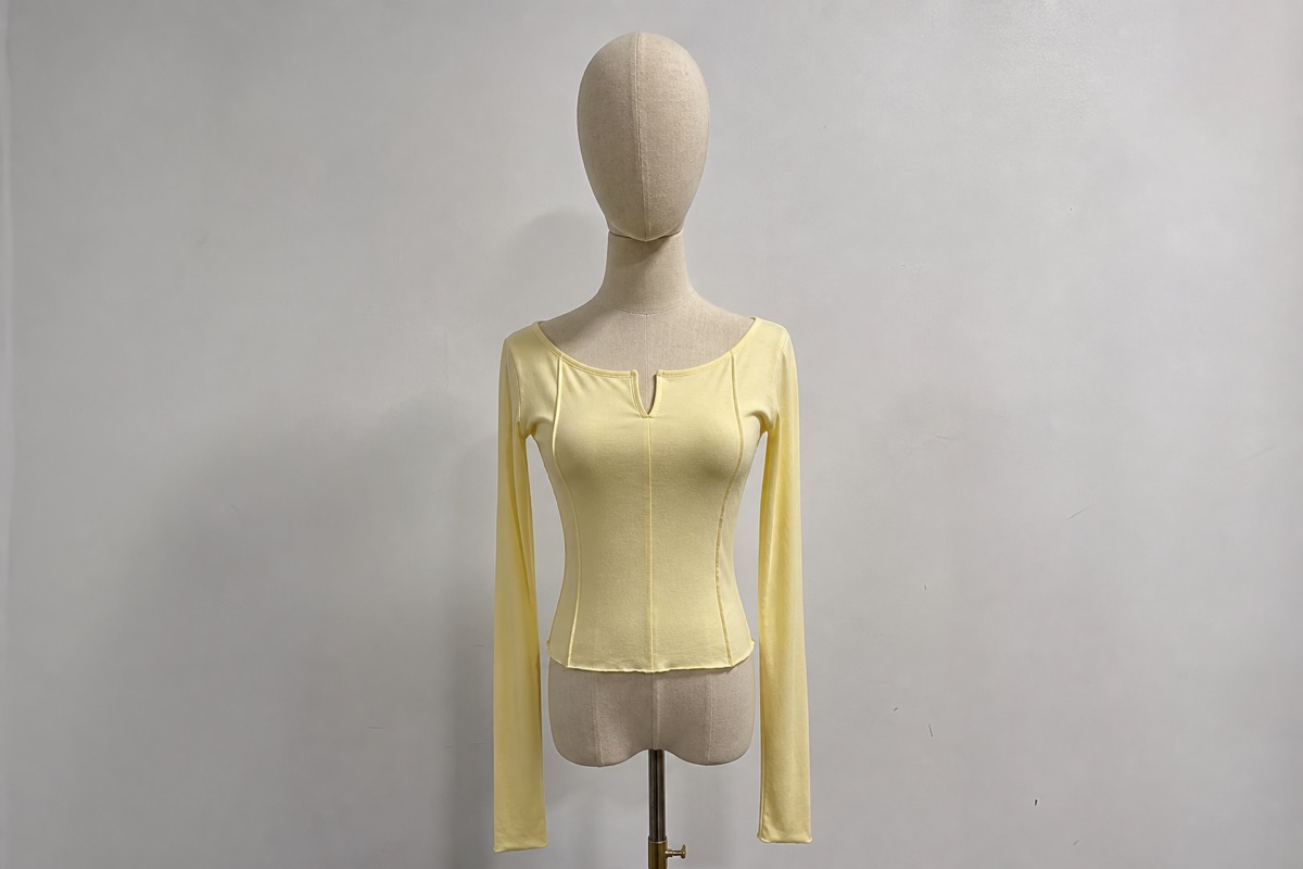 Yellow long sleeve women's top on mannequin for custom tops manufacturing