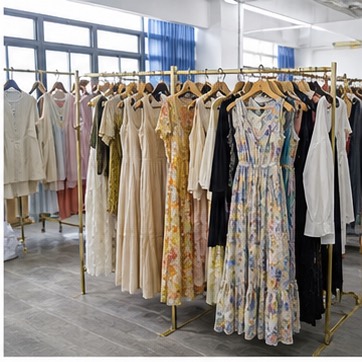 Sample room with custom women's dresses on racks
